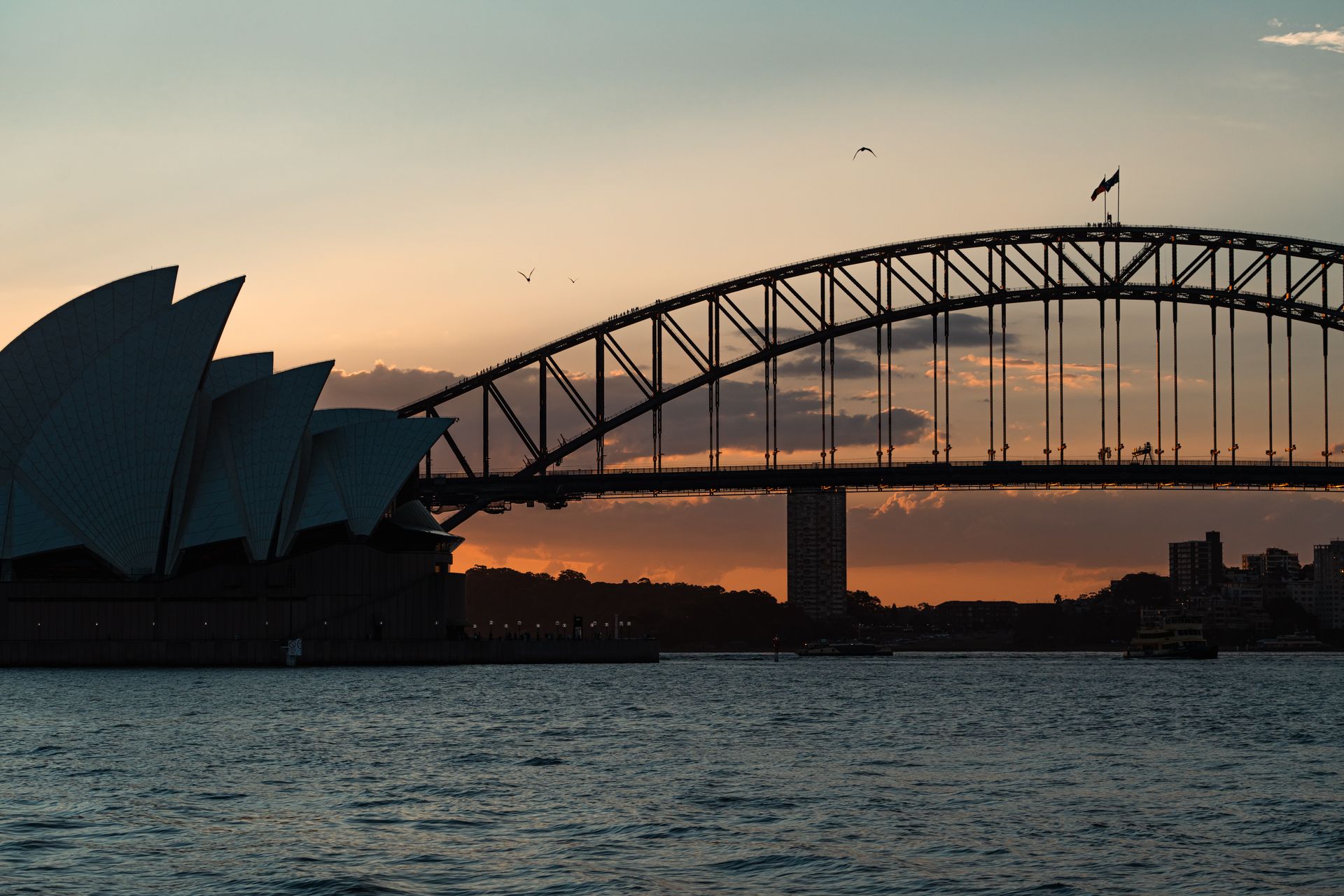 Sydney Opera House and the Harbour Bridge silhouetted at dusk
